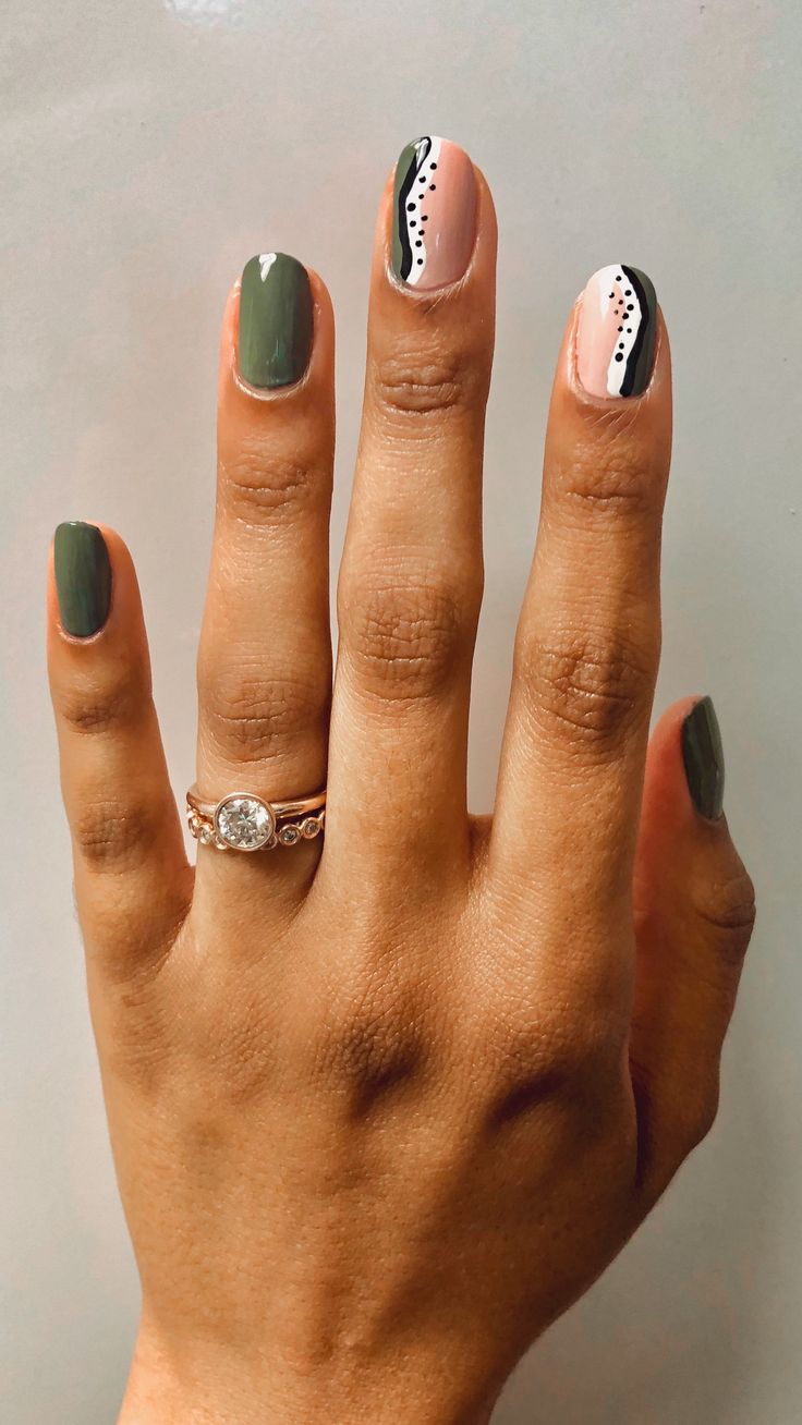 Trendy Chic Nail Design: Earthy Green, Soft Pink, and Bold Black Patterns with Playful Dots.