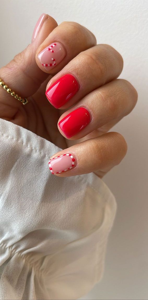 Playful Chic Nail Design: Bold Red and Soft Pink with Delicate Accents.