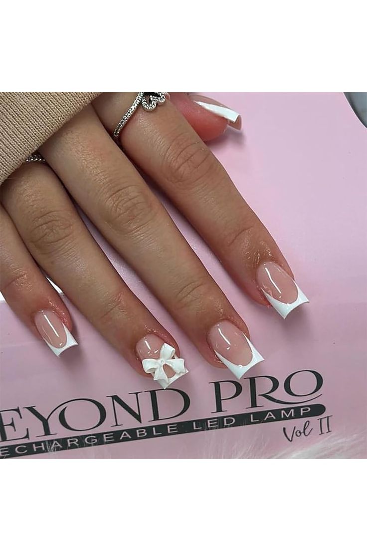 Chic French Tip Nails with Modern Bow Accent