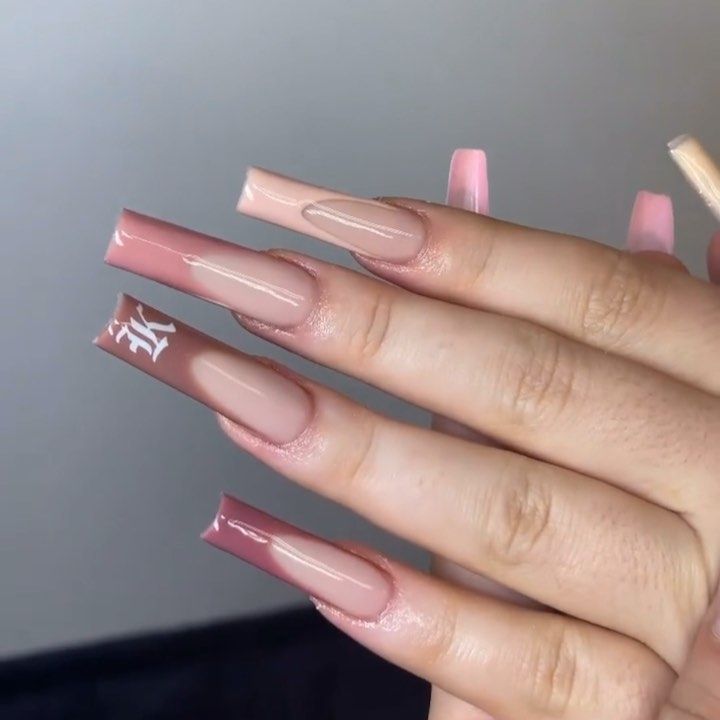 Elegant Chic Manicure: Stylish Nude and Pink Nail Design with Glossy Finish and Unique Accent.