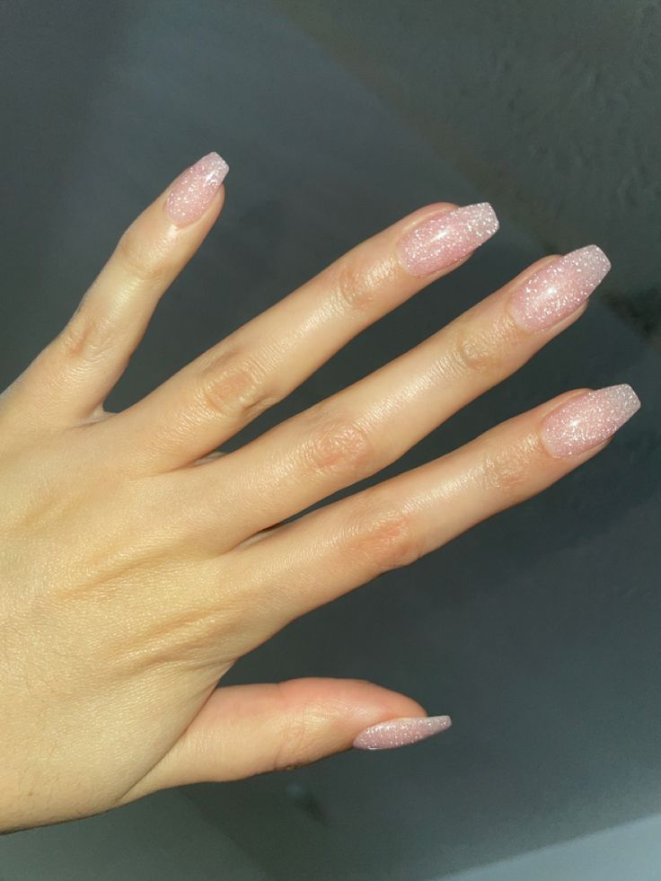 Elegant Almond-Shaped Pink Glitter Nails: A Perfect Blend of Glamour and Sophistication for Any Occasion.