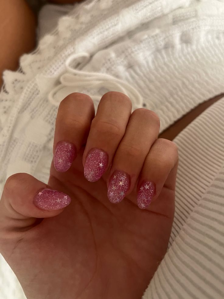 Whimsical Ombre Pink Nails with White Star Patterns for Unique Style