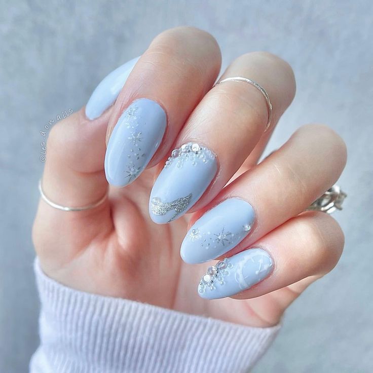 Serene and Elegant Blue Nail Art with Intricate Designs and Silver Embellishments