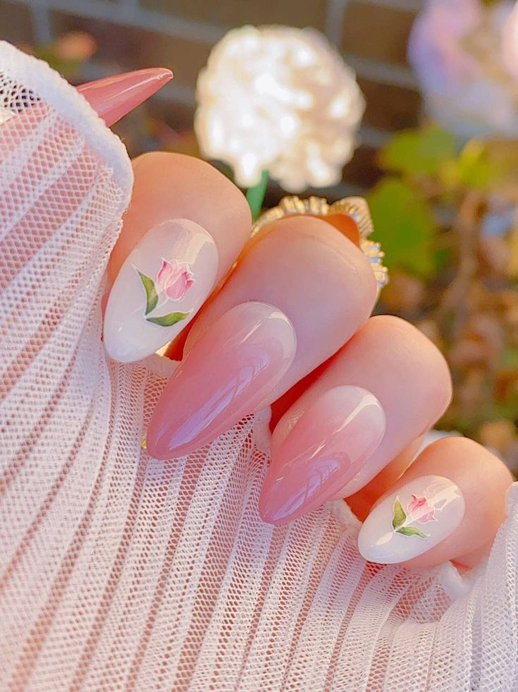 Charming Elegant Nail Design: Soft Pink Gradient with Almond Tips and Hand-Painted Rose Motifs.