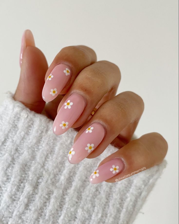 Chic Floral Almond Nail Design: Soft Pink Base with Delicate White Daisies for a Fresh Spring Look.