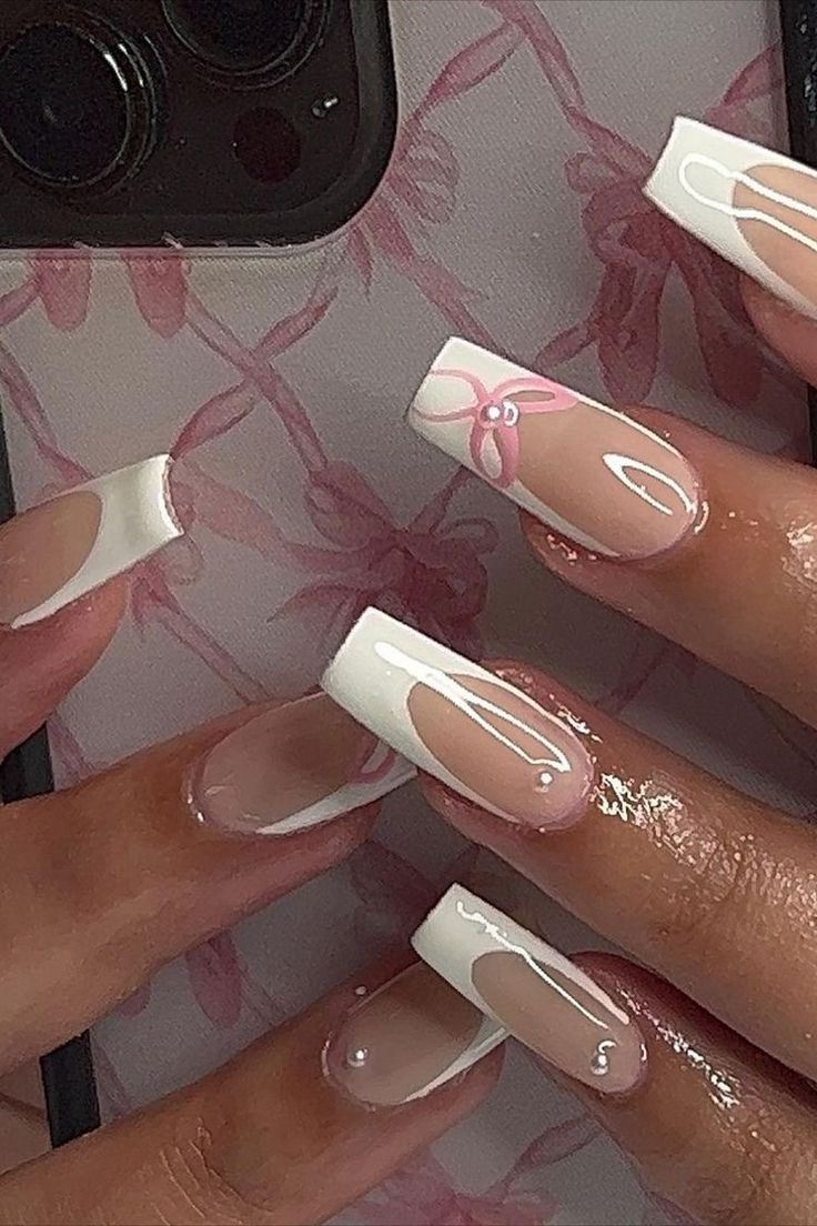 Chic Clear and White Nail Design with Delicate Pink Floral Accents.