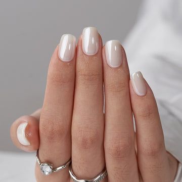 Sophisticated Ombre Nail Design with Glossy Finish and Dainty Accents.