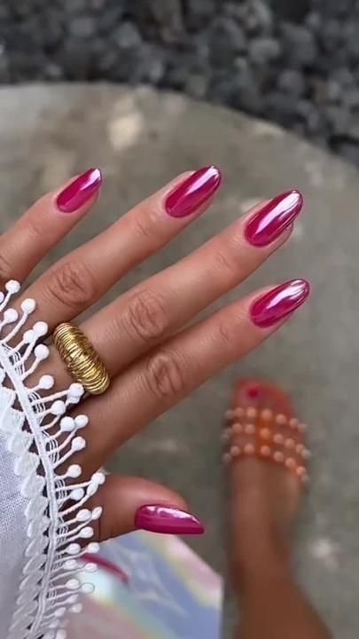 Glamorous Glossy Fuchsia Manicure with Pointed Nails and Textured Accessories for Summer Elegance.