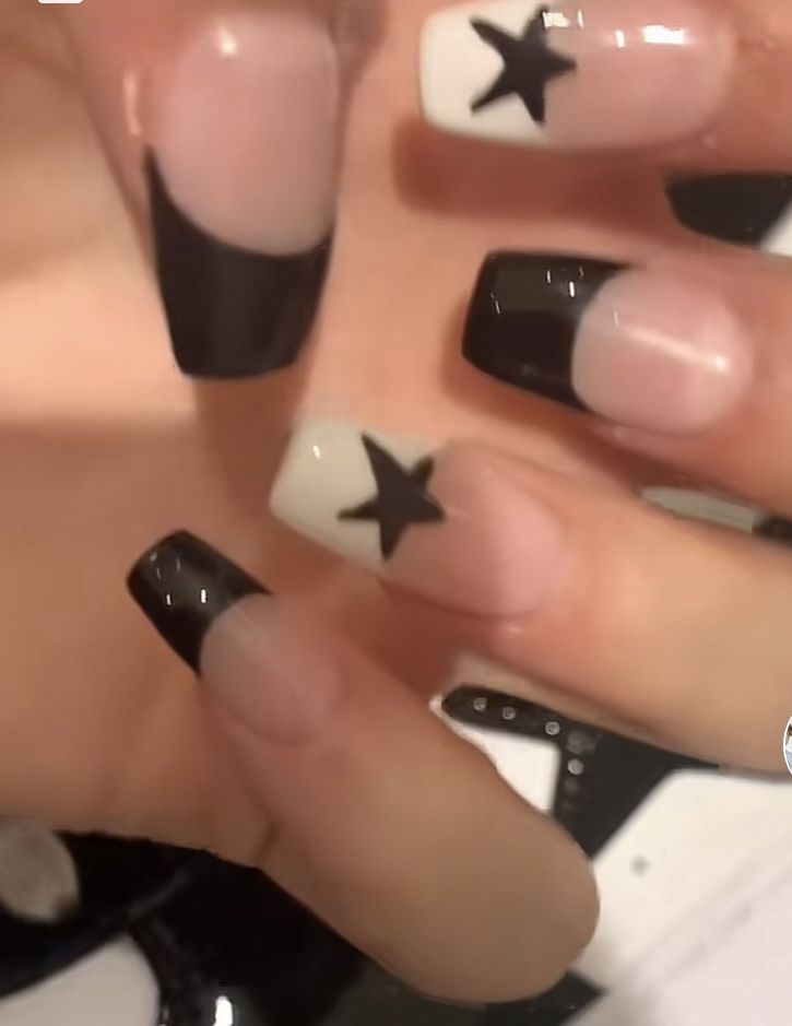 Chic Nail Design: Bold Black and Nude with Playful White Star Accents