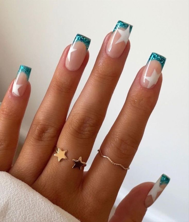 Chic Turquoise Tip Nail Design with White Star Accents for a Playful Sophistication.