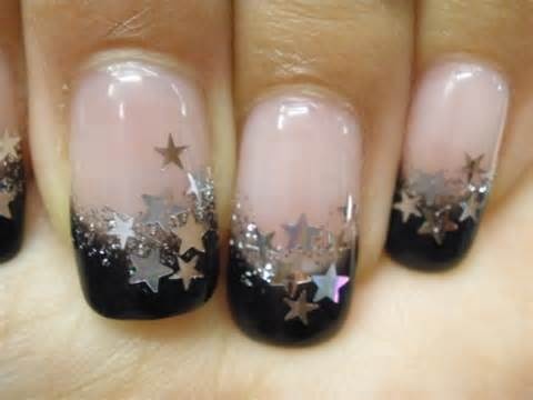 Celestial Gradient Nail Design: Soft Nude to Bold Black with Glittering Stars