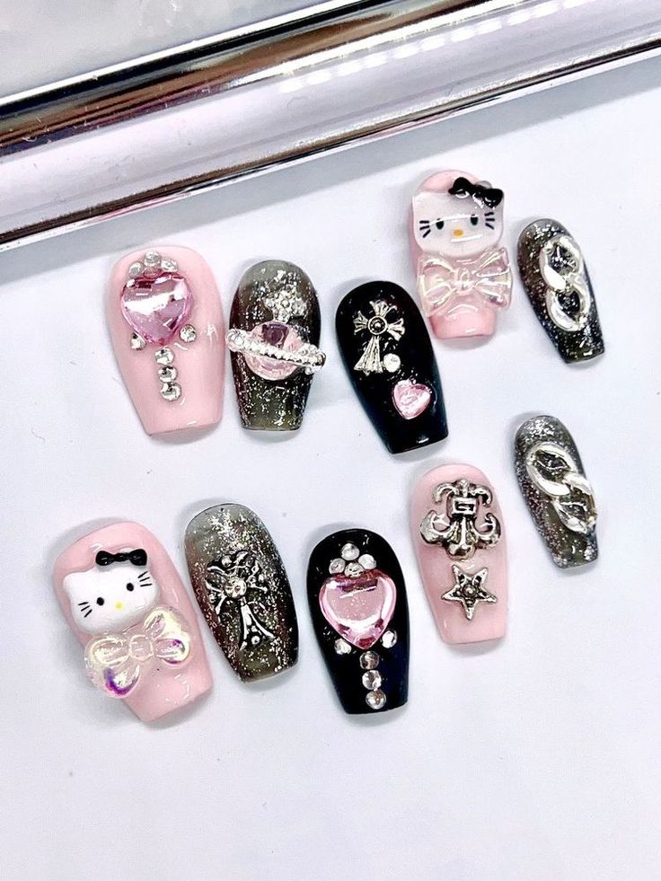 Playful Pastel and Bold Black Nail Art with Whimsical Designs and Sparkling Embellishments.