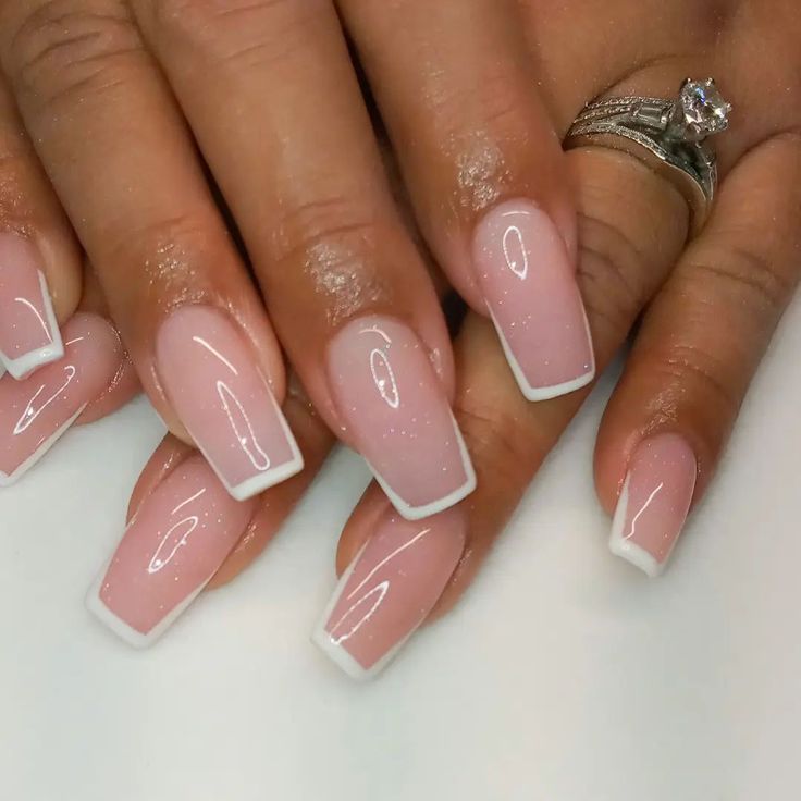 Sophisticated Soft Pink French Manicure with Shimmering Accents.