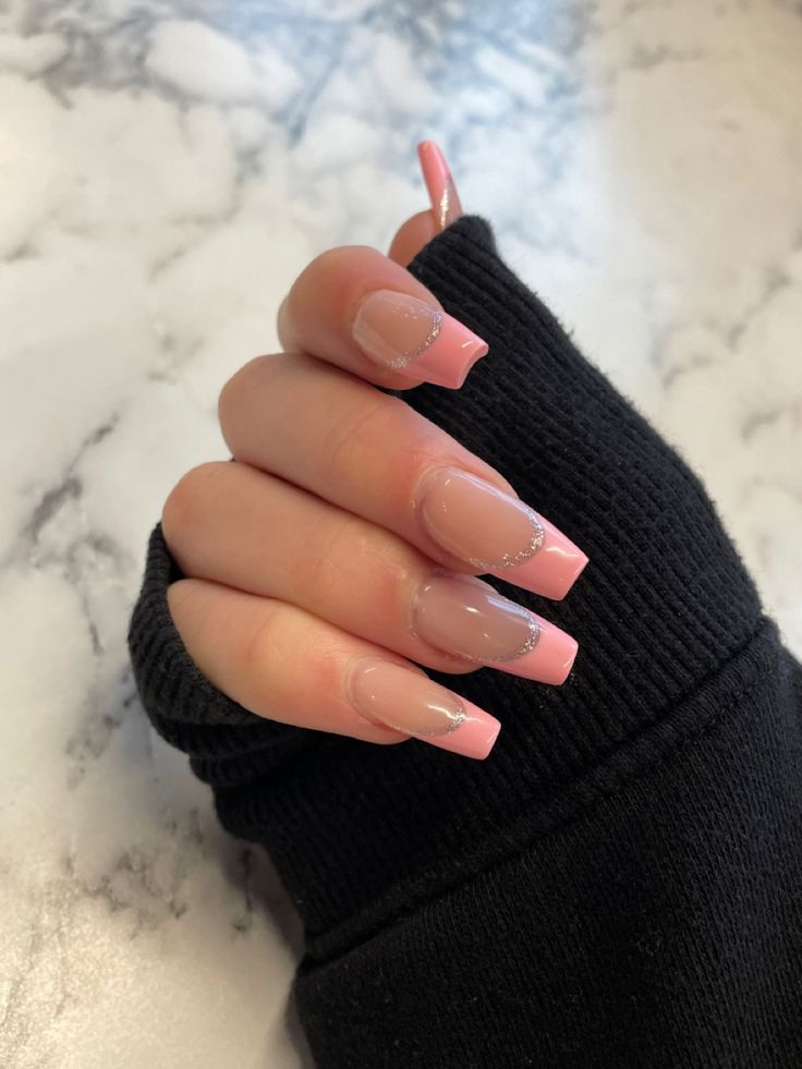 Sophisticated Nail Art: Soft Pink and Nude Design with Glittery Tips.