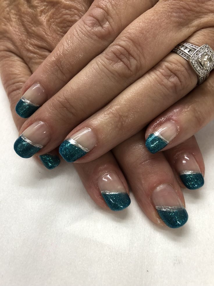 Chic Glittery Teal French Tips with Half-Moon Design and Metallic Accents