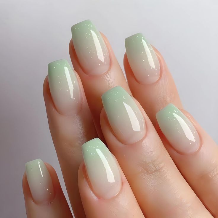 Elegant Pale Green Ombre Nail Design with Subtle Sparkle and Clean-Cut Tips.