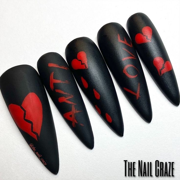 Rebellious Nail Design: Matte Black Background with Bold Red Hearts and Lettered Accents.