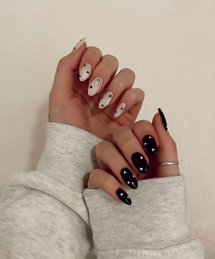 Bold and Sophisticated Modern Nail Art: Glossy Black and White with Abstract Patterns.