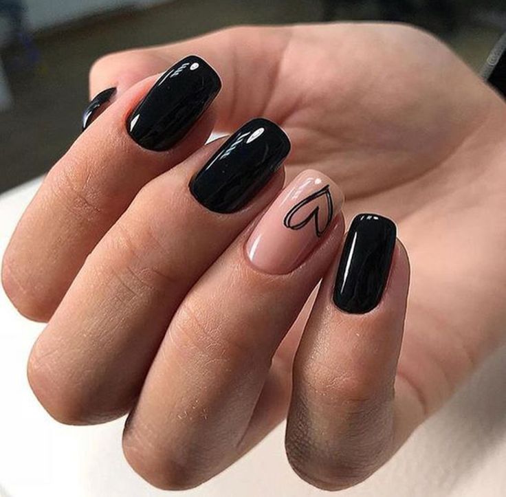 Chic Black and Nude Nail Design: A Bold Contrast with Elegant Heart Accent.