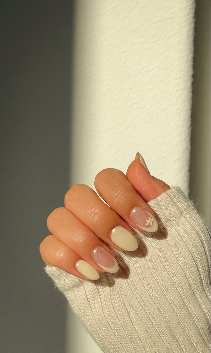 Chic Almond-Shaped Nails with Nude and Beige Floral Accents for a Whimsical Touch.