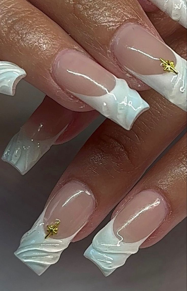 Elegant White and Transparent Nail Design with Wavy Pattern and Golden Accents.