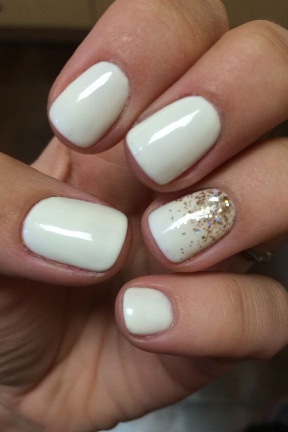 Glamorous Elegant White Nail Design with Glossy Finish and Glitter Accent.