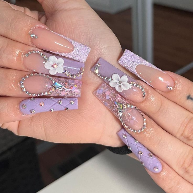 Elegant Lavender Nail Design with Crystal Embellishments and Floral Accents.