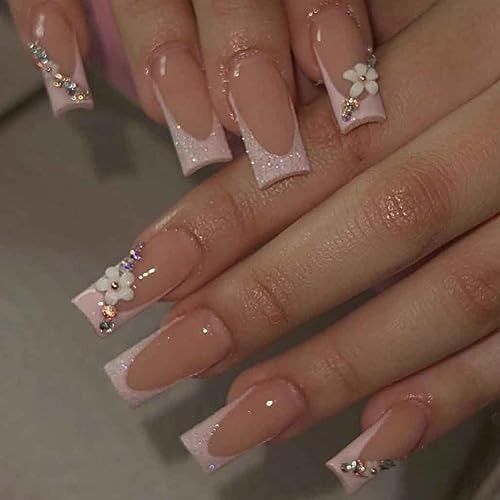 Refined Nude Nail Design with Shimmering Pink Accents and Floral Embellishments.