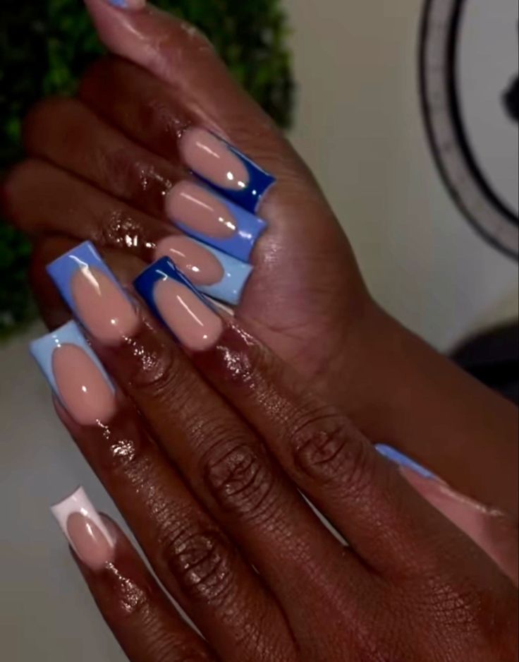 Contemporary Nail Art: Stylish Nude and Vibrant Blue Design with Glossy Finish and Artistic Flair