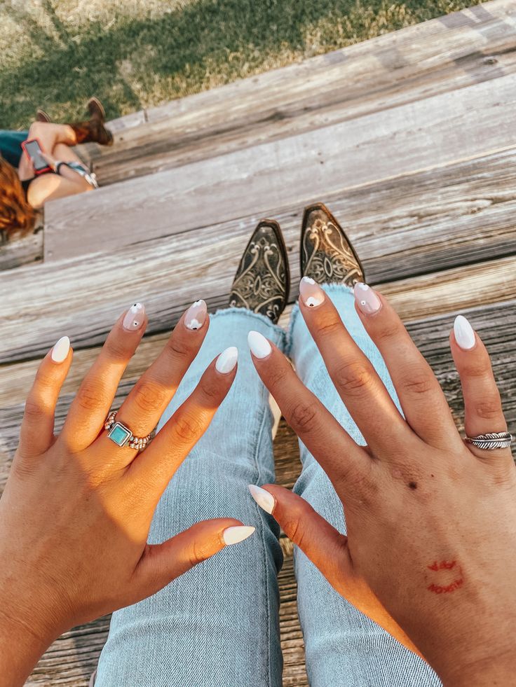 Sophisticated White Nail Art with Almond and Oval Shapes Enhanced by Subtle Accents for Summer Style.