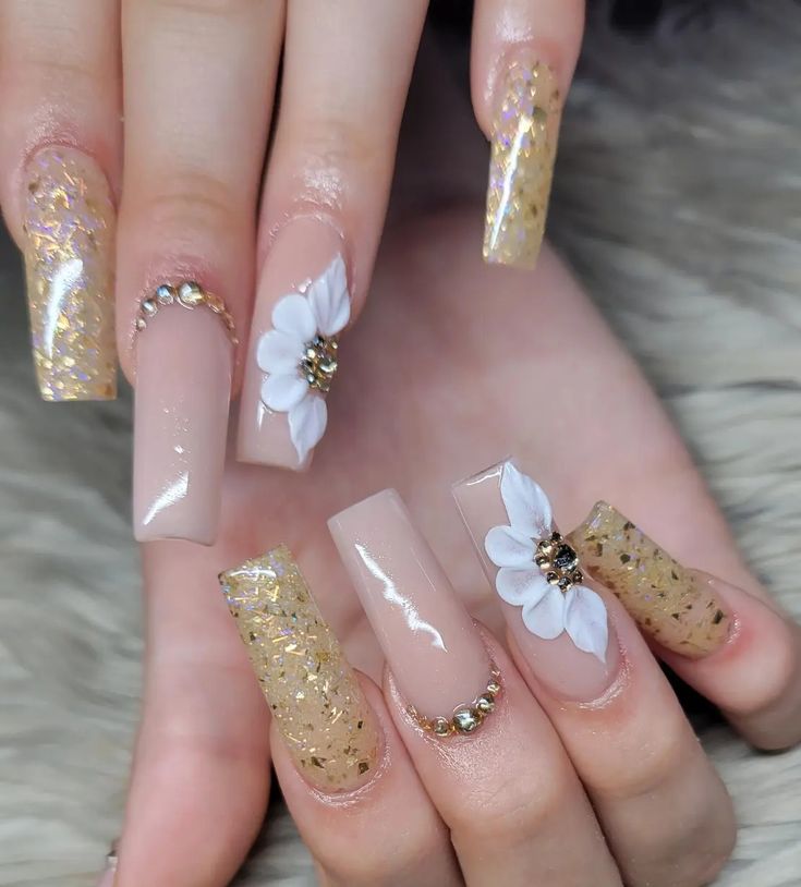 Chic Festive Nail Design: Elegant Long Nude and Gold Nails with Floral & Gem Accents