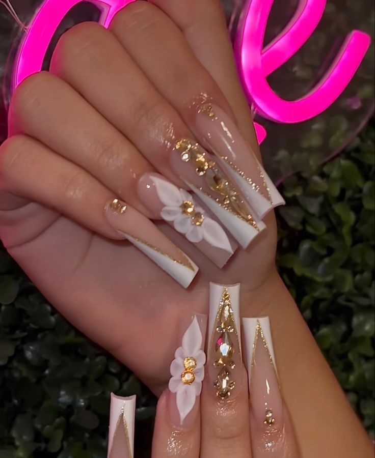 Luxurious Nail Design with Elongated Acrylic Tips, Elegant Hues, and Floral Accents.