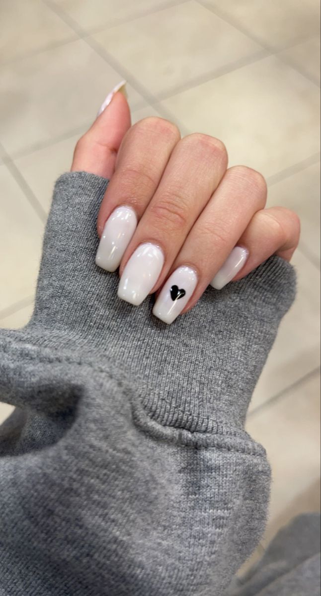 Chic Soft Glossy Nail Design with Gradient and Black Heart Accent.