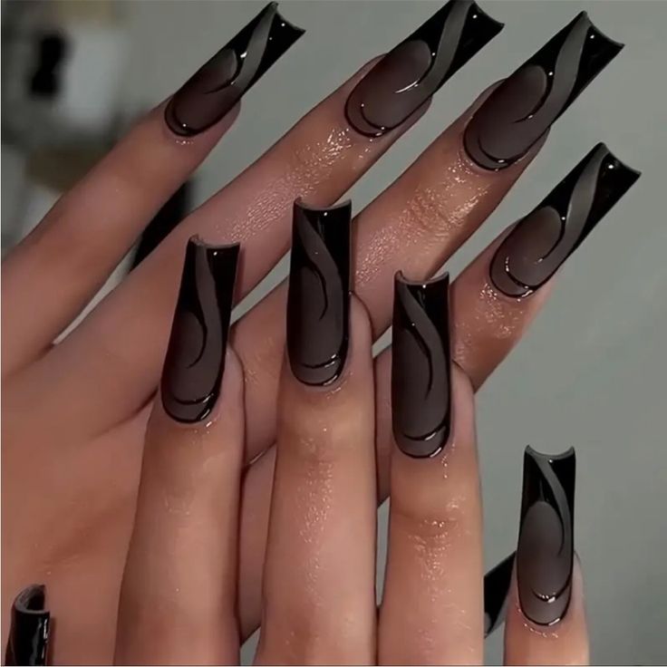 Elegant Dark-Colored Elongated Nails with Glossy Finish and Abstract Designs for a Bold Statement.