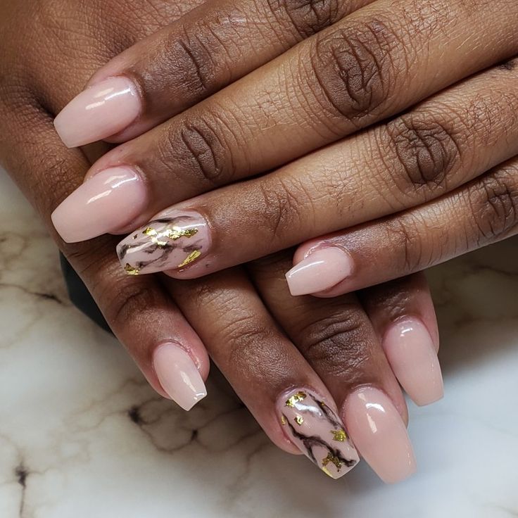 Sophisticated Nude Nail Design with Marble Accents and Gold Foil Details