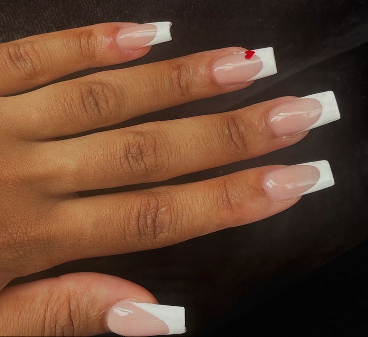 Sophisticated French Tip Manicure with Bold Red Accent.