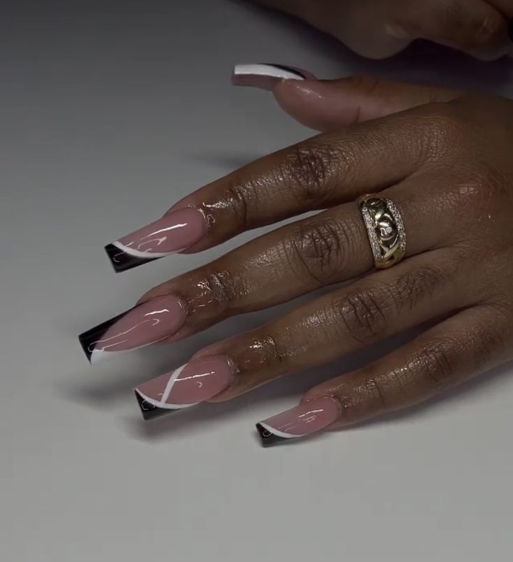 Sophisticated Nude and Black Nail Design with Modern Geometric Accents