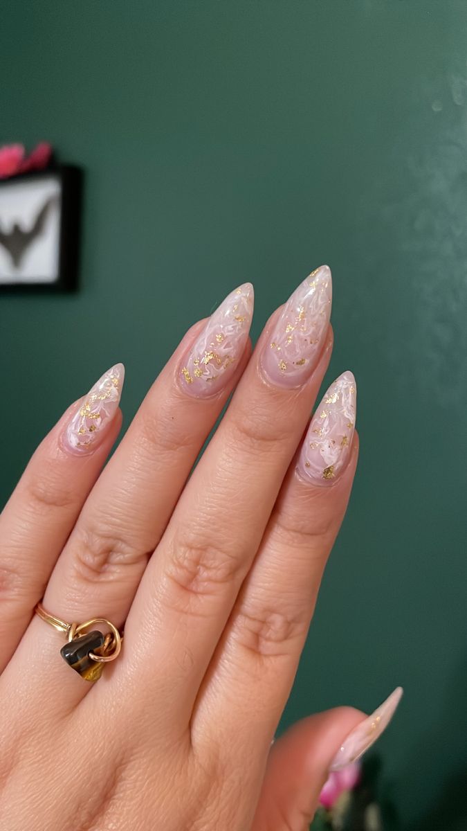 Sophisticated Elegant Nail Design with Pointed Tips and Soft Pink-Gold Swirls