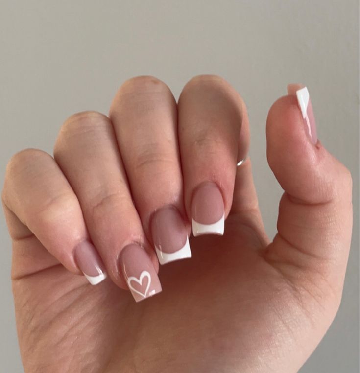 Chic French Manicure with Playful Heart Design for Any Occasion.