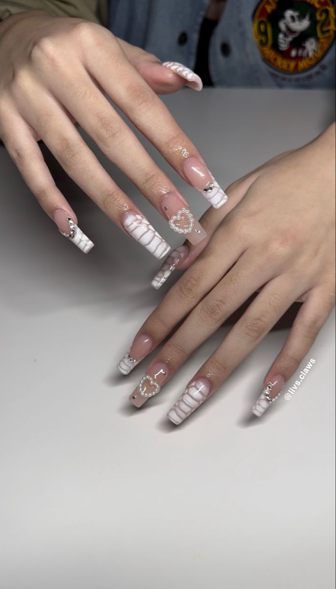 Elegant Acrylic Nail Design: Glamorous White and Nude French Tips with Intricate Details.