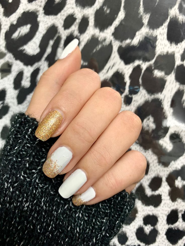 Chic White and Gold Nail Design: A Glamorous Blend of Sparkly Accents and Sleek Matte Finish.