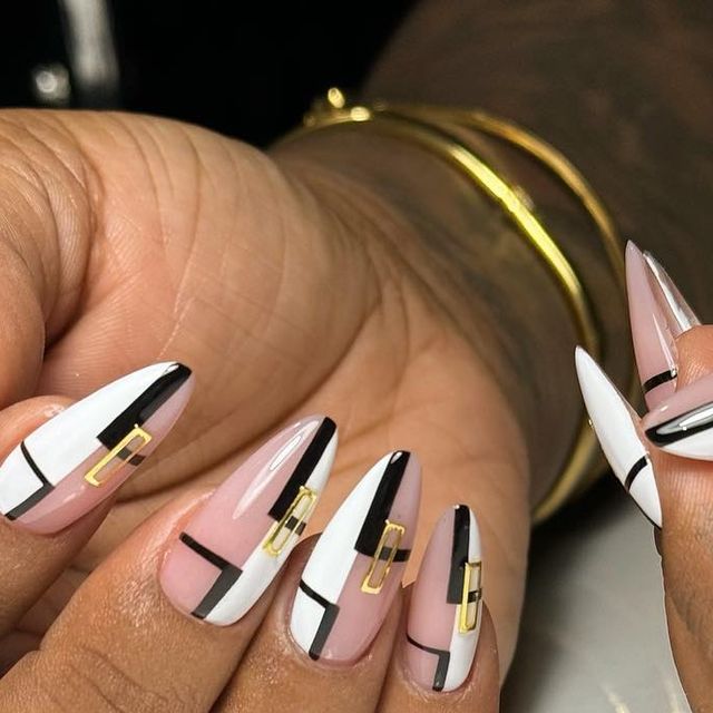 Sophisticated Geometric Nail Design in Nude, Black, and White with Gold Accents