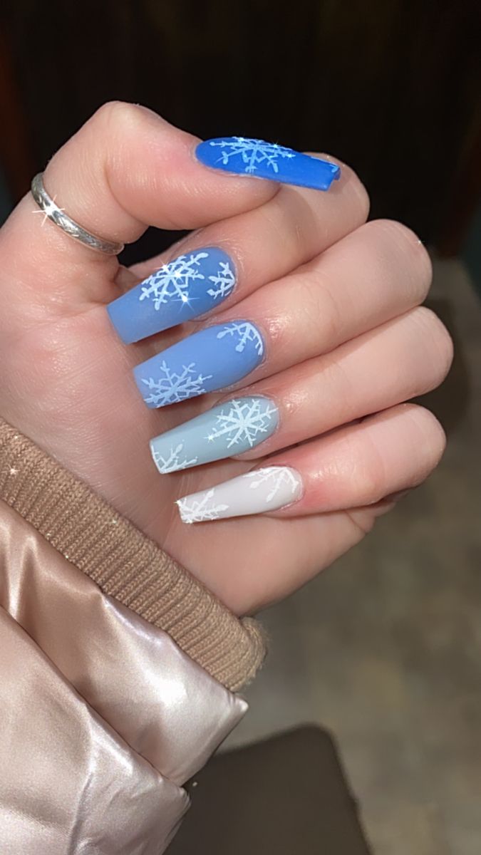 Chilly Elegance: Winter-Inspired Icy Blue Gradient Nail Design with Snowflake Details.