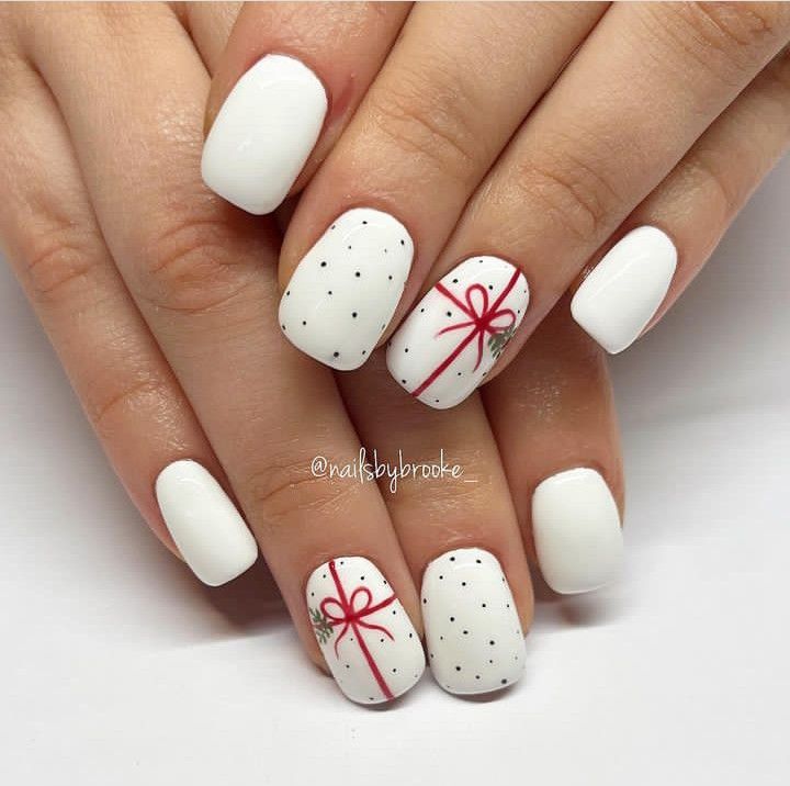 Charming Festive Nail Design: Clean White Base with Red Bows and Polka Dot Accents