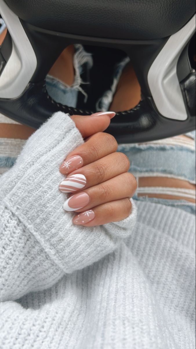 Chic Seasonal Nail Design: Elegant Beige and White Stripes with Snowflake Accents