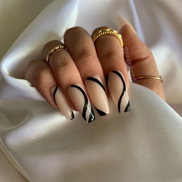 Chic Nude and Black Wave Nail Design with Gold Accents