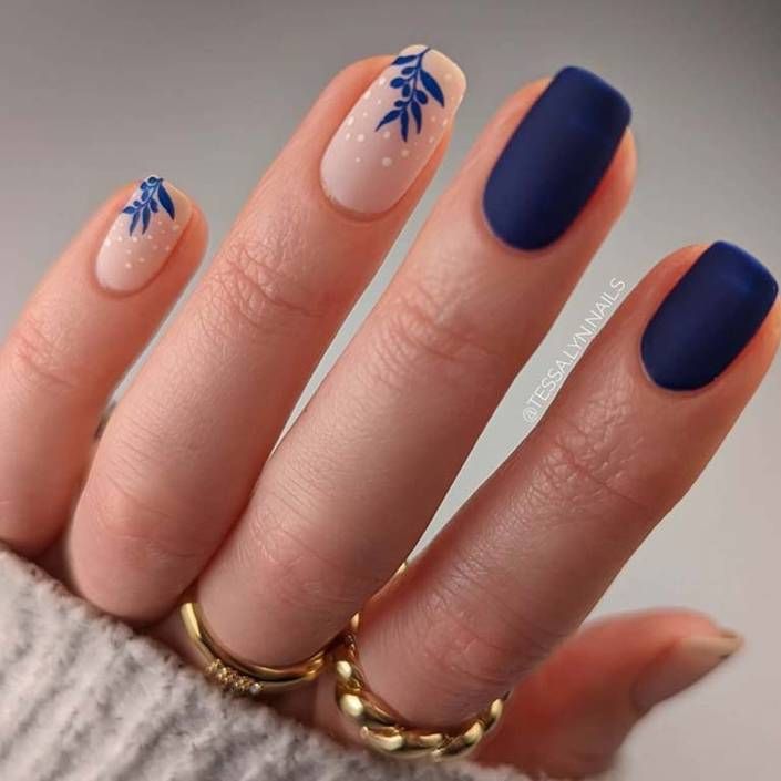 Elegant Chic Nail Design: Striking Pastel and Navy Contrast with Floral Accents.