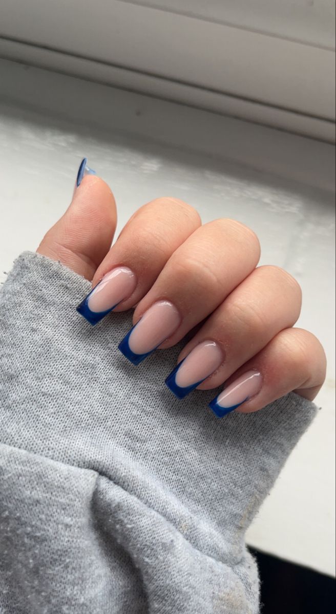 Chic Modern French Manicure: Soft Nude Base with Striking Blue Tips.