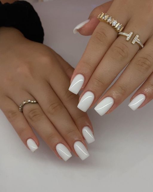 Sophisticated Elegant White Manicure with Squared Shape and Chic Gold Rings.