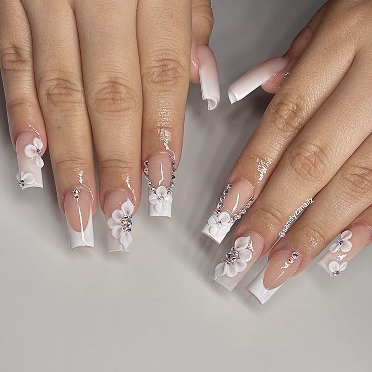 Elegant Floral-Patterned Nail Design with Soft Pastels and Shimmering Accents.